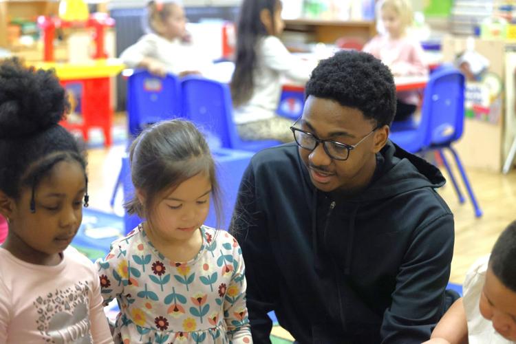 Park High School senior assisting young students  at Bull Early Education Center